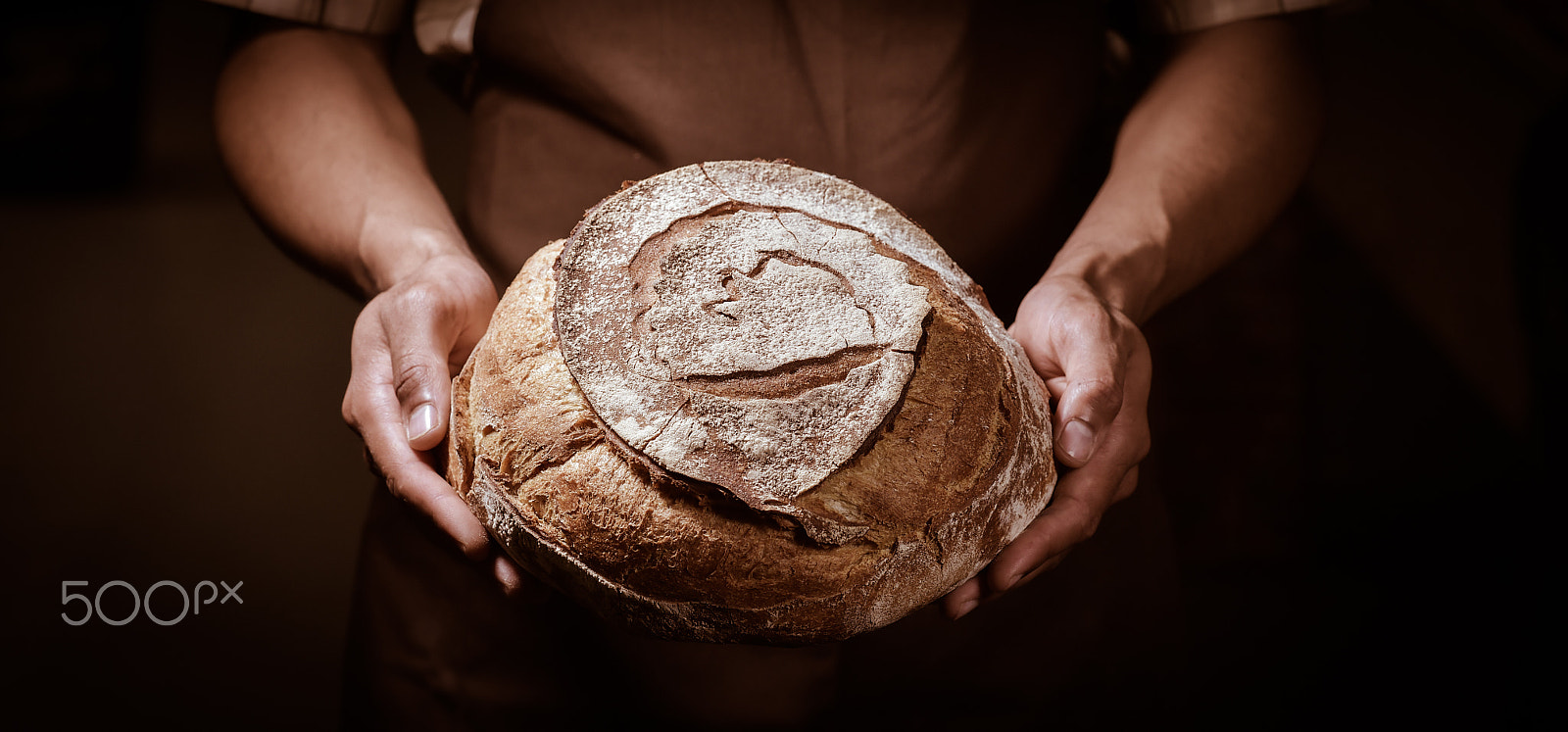 Nikon D4S + Nikon AF-S Nikkor 85mm F1.4G sample photo. Baker man holding a round bread photography