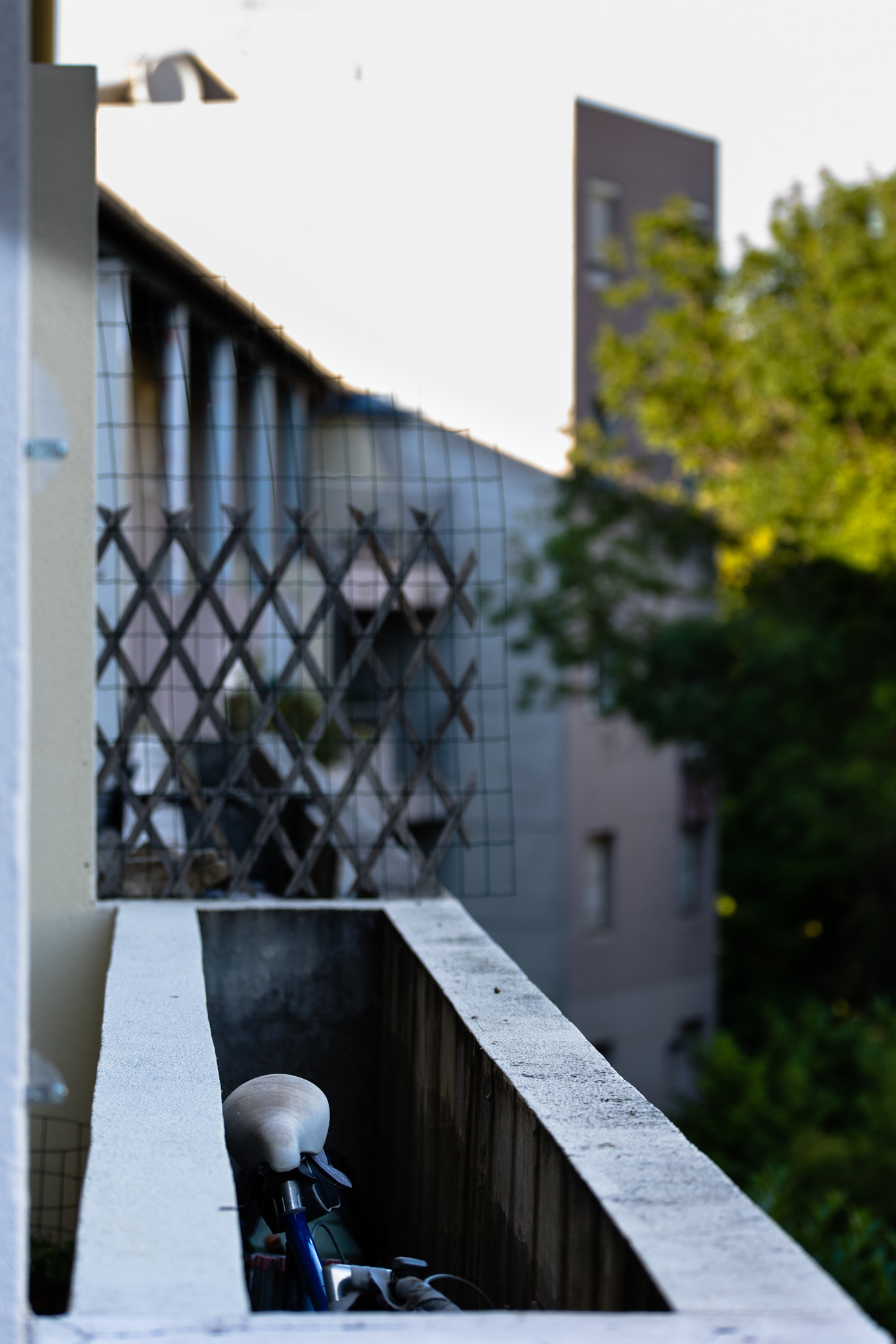 Nikon D3300 + Sigma 50-150mm F2.8 EX APO DC OS HSM sample photo. Bike hidden on a balcony photography