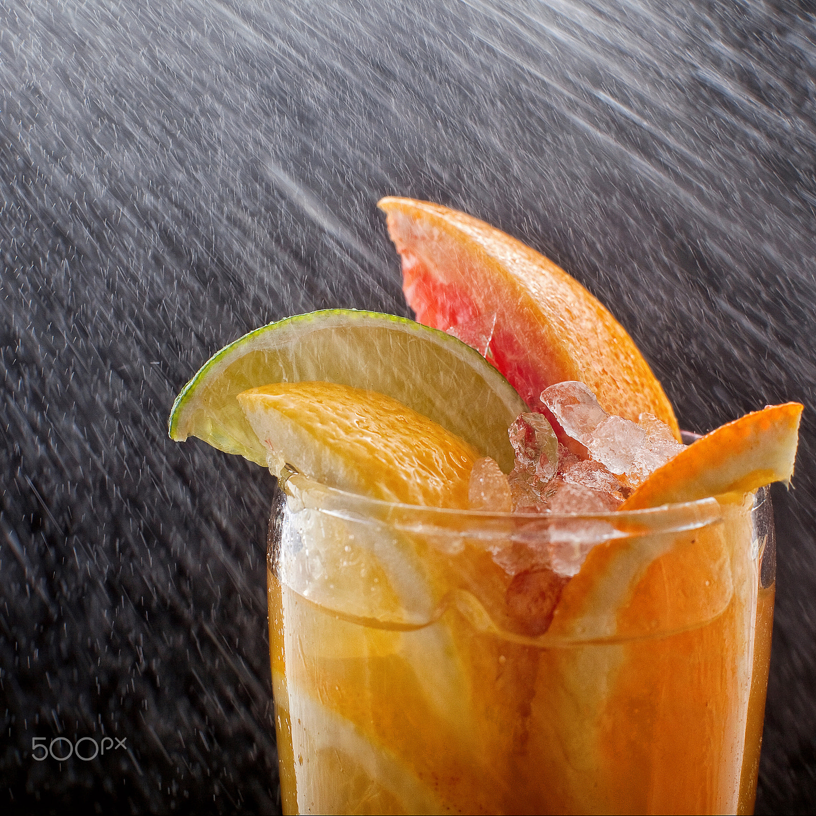 Canon EF 50mm F1.4 USM sample photo. Chilled soft drinks with ice, citrus fruits and berries, black background, selective focus drop photography
