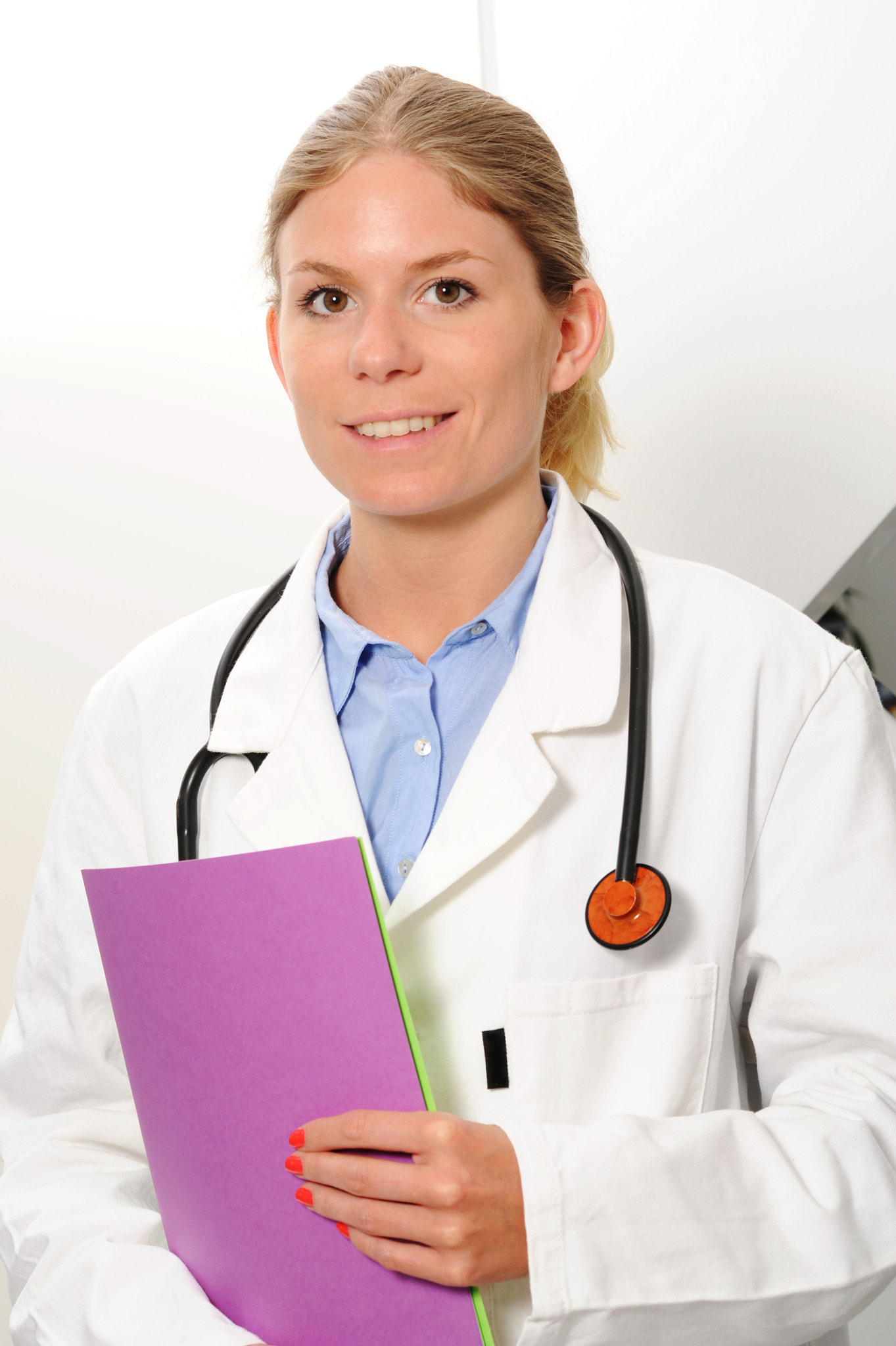 Nikon D3S + Nikon AF-S Nikkor 85mm F1.4G sample photo. Smiling woman doctor closeup with  files in arms photography