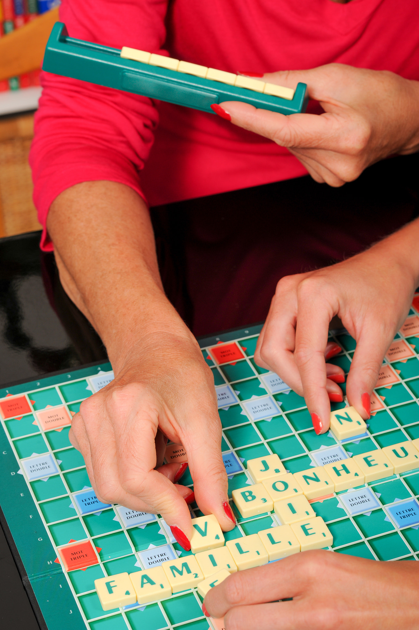 Nikon D3S + Nikon AF-S Nikkor 85mm F1.4G sample photo. Happy senior woman playing scrable with daugther photography
