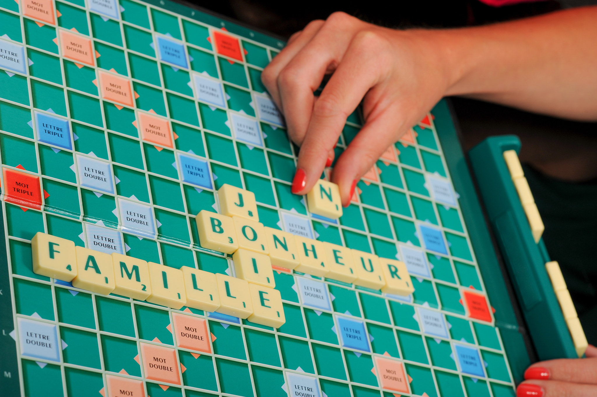 Nikon D3S + Nikon AF-S Nikkor 85mm F1.4G sample photo. Happy senior woman playing scrable with daugther photography