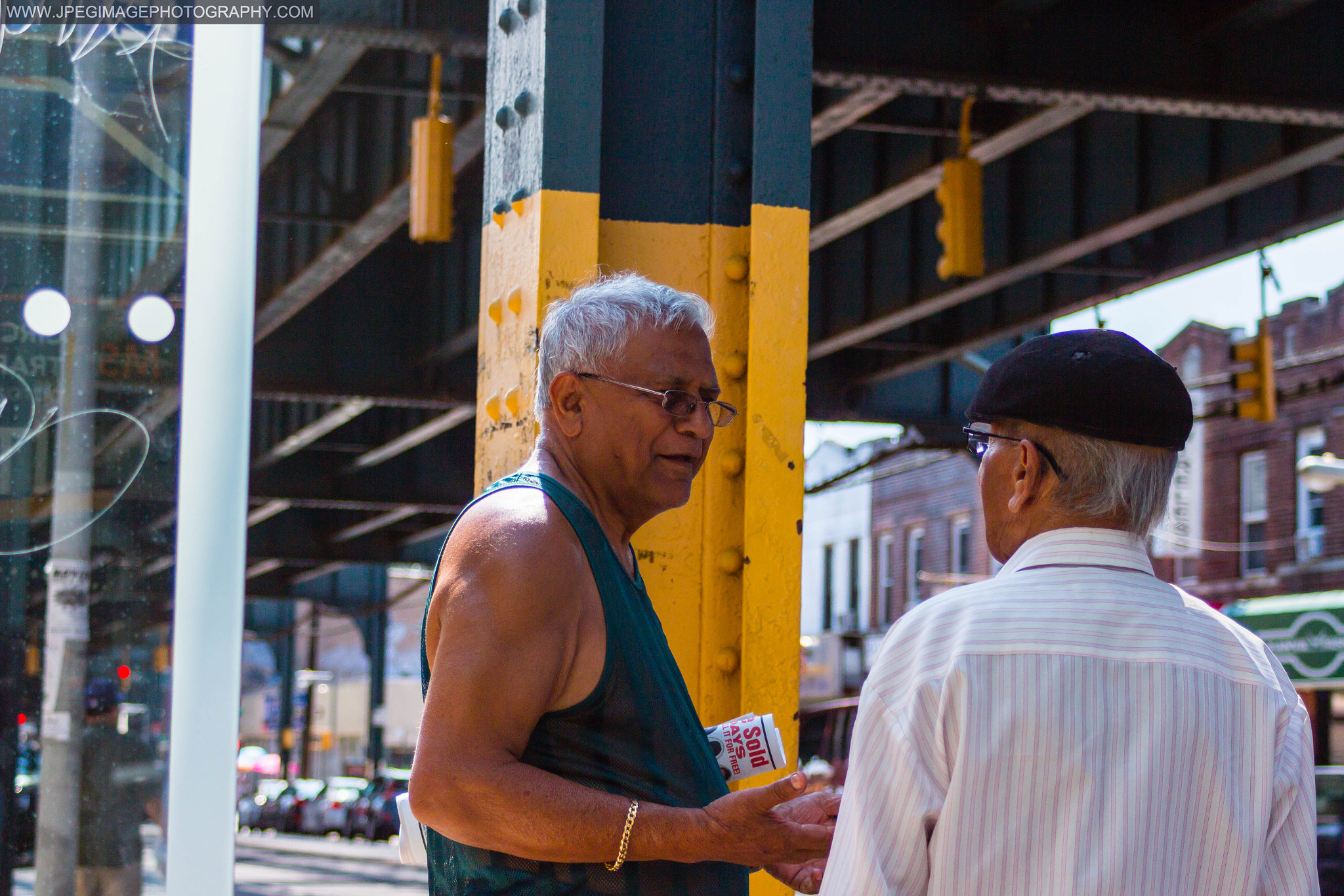 Canon EOS 600D (Rebel EOS T3i / EOS Kiss X5) + Canon EF 28-90mm f/4-5.6 sample photo. Two men having a conversation at a mta bus stop on liberty ave in ozone park, queens new york.... photography