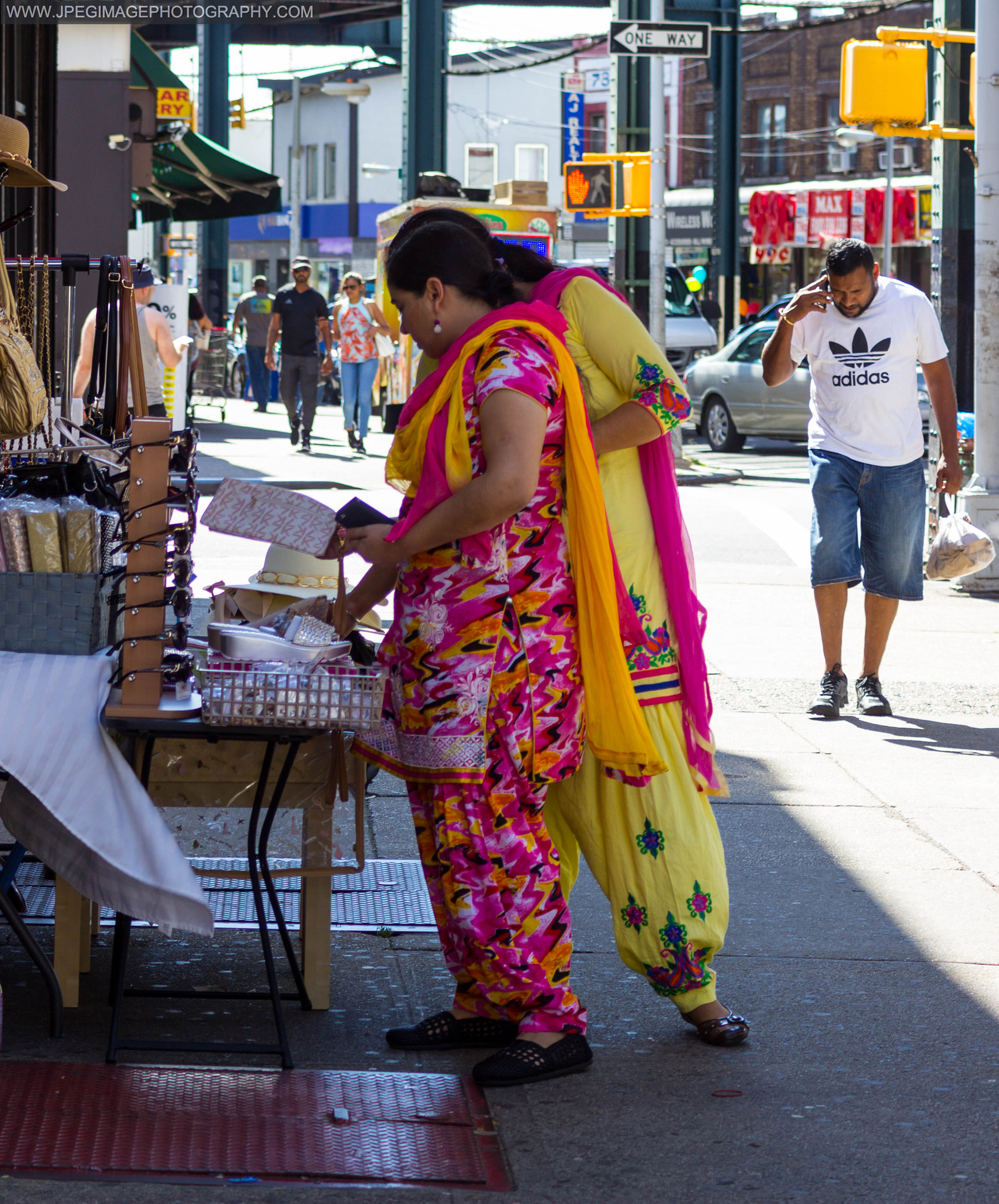 Canon EOS 600D (Rebel EOS T3i / EOS Kiss X5) + Canon EF 28-90mm f/4-5.6 sample photo. Two women reviewing items to purchase from a local street vendor in ozone park, queens new york.... photography