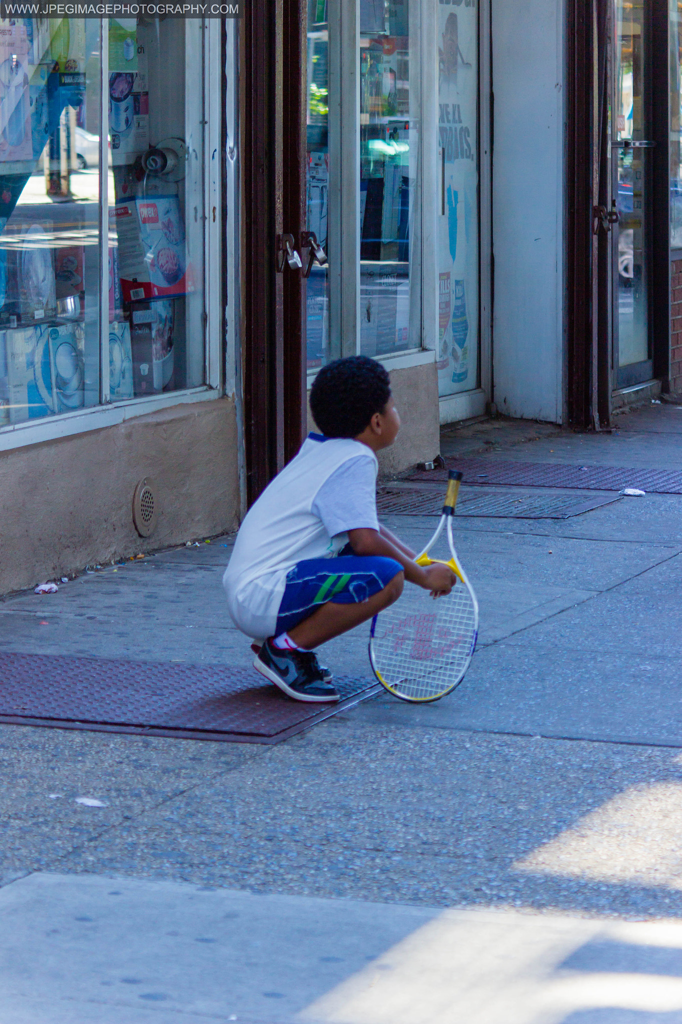 Canon EOS 600D (Rebel EOS T3i / EOS Kiss X5) + Canon EF 28-90mm f/4-5.6 sample photo. Young child holding a tennis racket, in ozone park, queens new york. august 7, 2016. photography