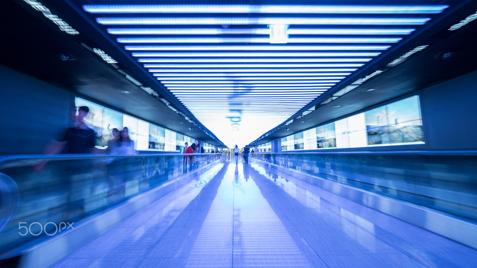 Panasonic Lumix DMC-GH4 + Olympus M.Zuiko Digital ED 7-14mm F2.8 PRO sample photo. Tunnel with flat escalators in airport of seoul photography