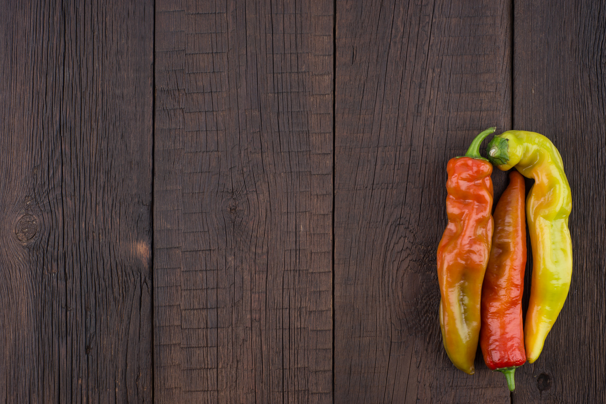 Sony a99 II + Minolta AF 50mm F1.7 sample photo. Chilli peppers on wooden background. photography