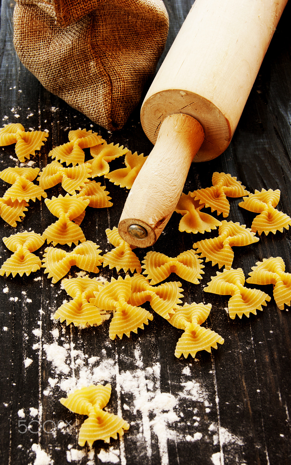 Sony Alpha DSLR-A380 sample photo. Uncooked pasta with flour on the table, selective focus photography