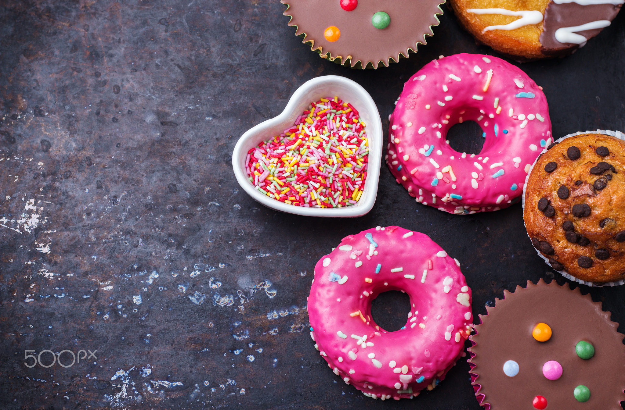 Colorful donuts on a grunge rusty table