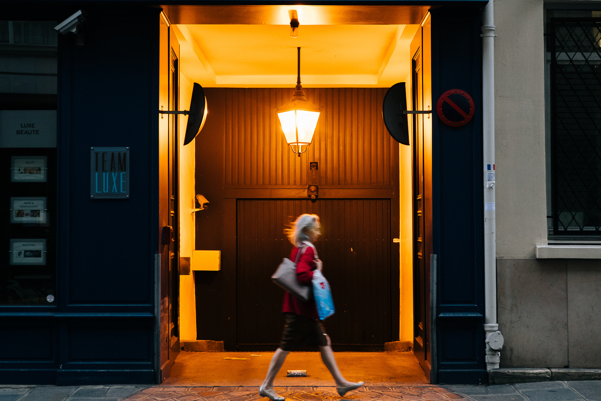 Sony a6300 + E 32mm F1.8 sample photo. Woman walking through the streets of paris photography