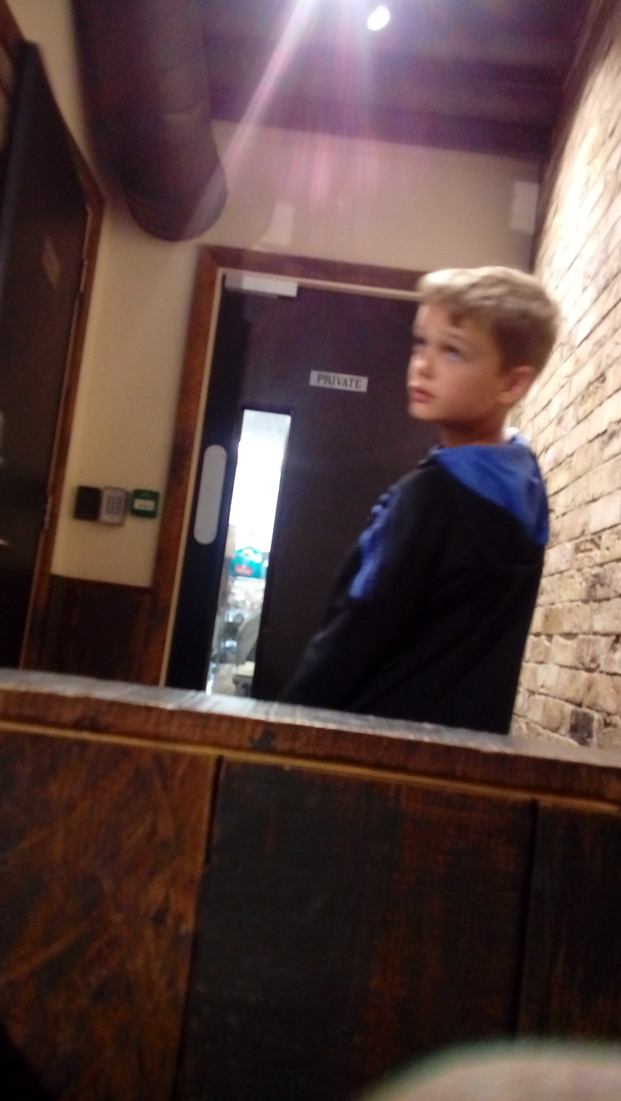 LG K350N sample photo. Young boy looking past camera photography