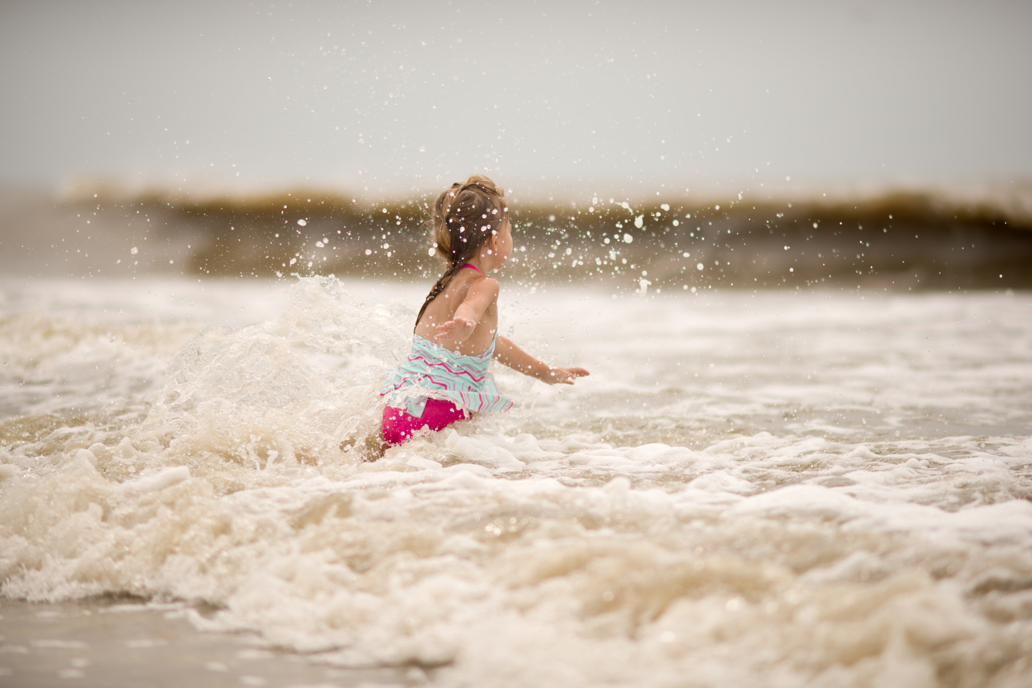 Nikon D610 + AF DC-Nikkor 135mm f/2D sample photo. Reese in the waves photography