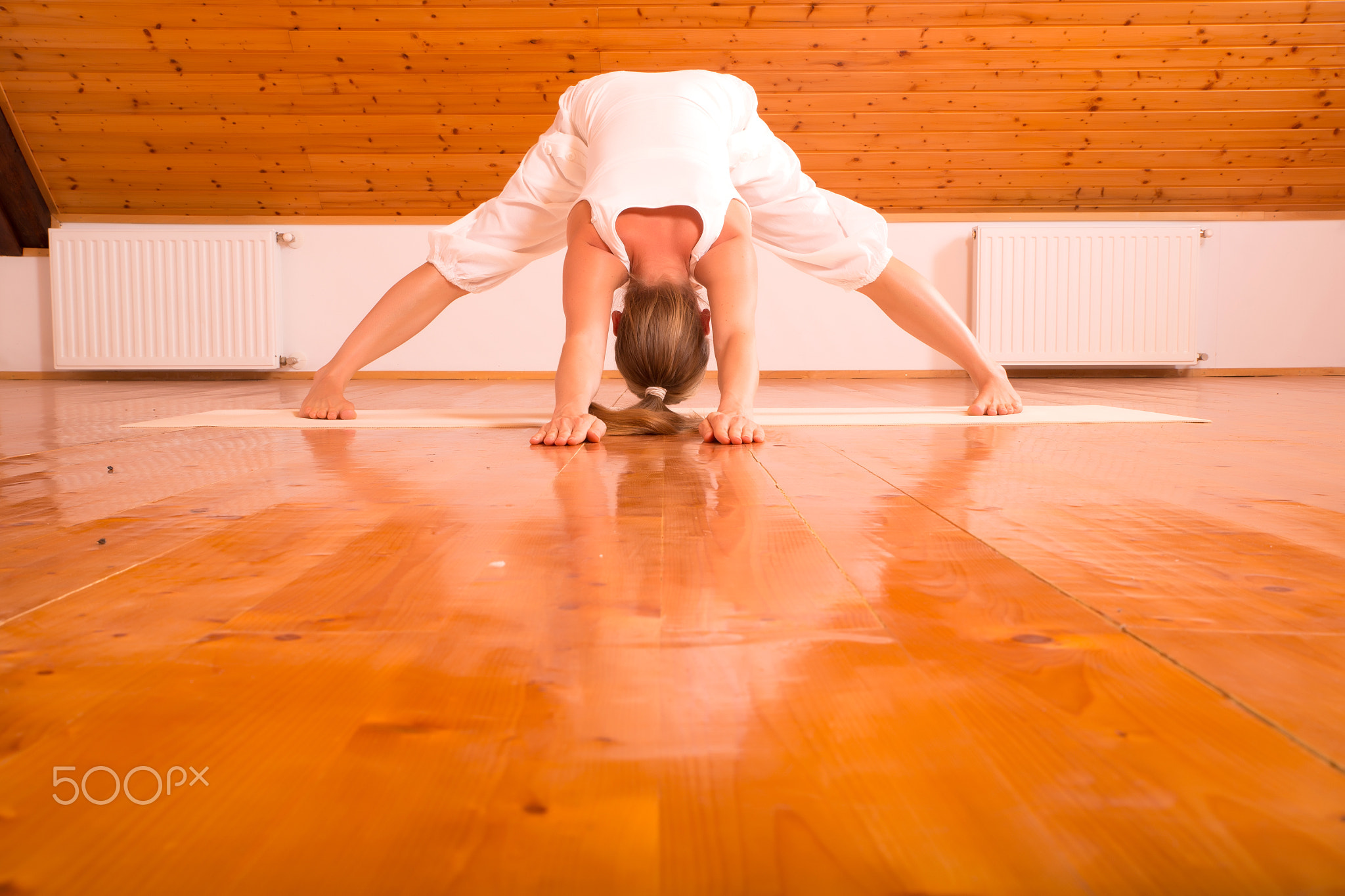 Woman practicing Yoga in a Studio