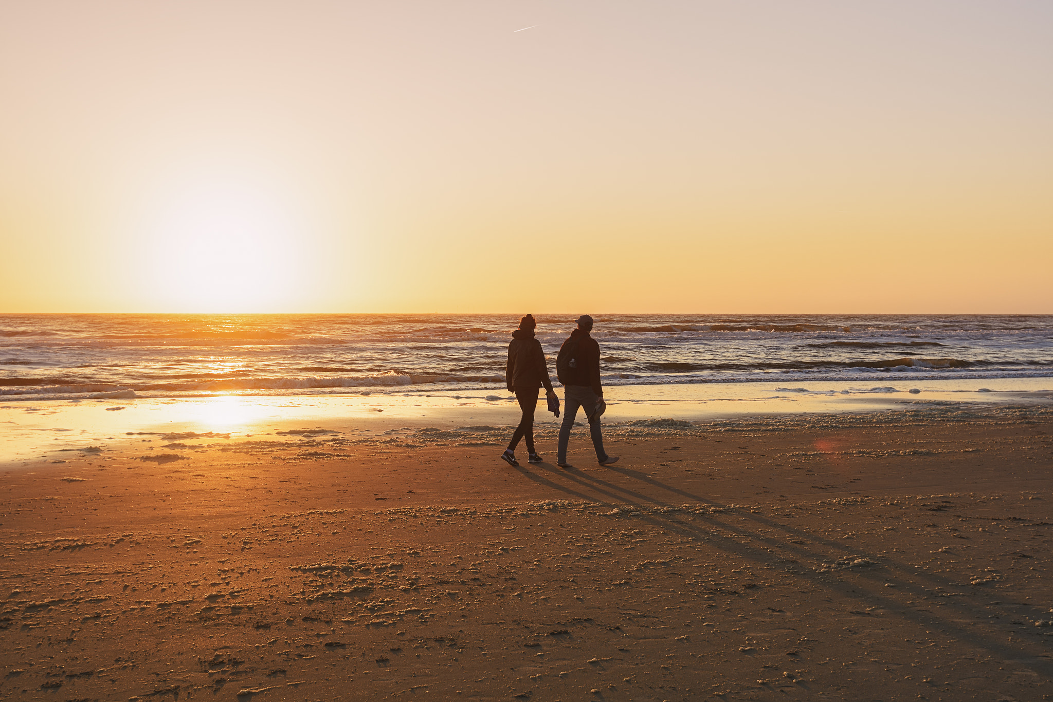Nikon AF-S Nikkor 16-35mm F4G ED VR sample photo. People walking on the beach during sunset. photography