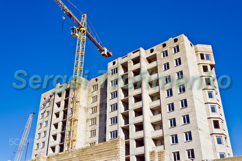 Construction crane against the blue sky