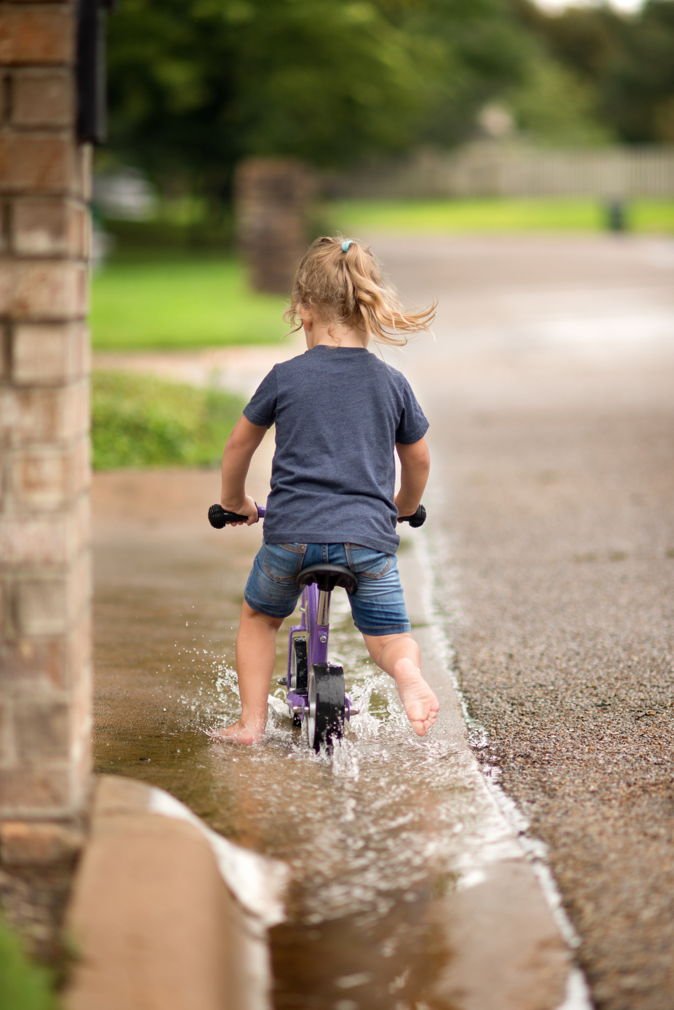 Nikon D610 + AF DC-Nikkor 135mm f/2D sample photo. Biking through the puddles photography