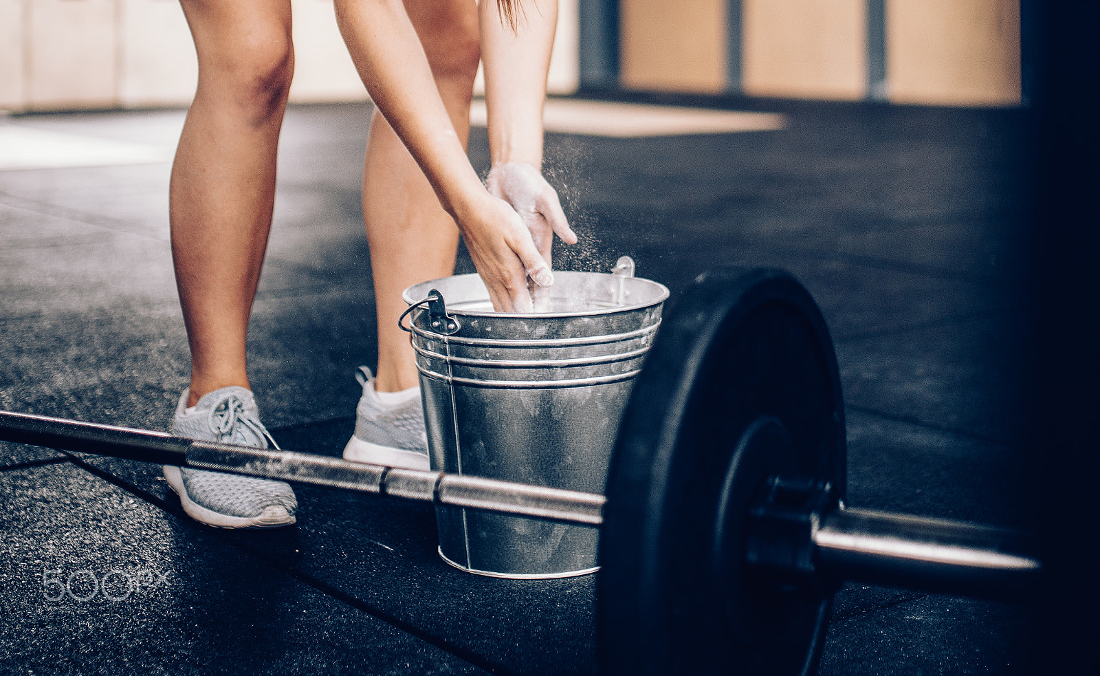 Canon EOS 5DS + Sigma 35mm F1.4 DG HSM Art sample photo. Young woman rubs hands in chalk before lifting barbell photography