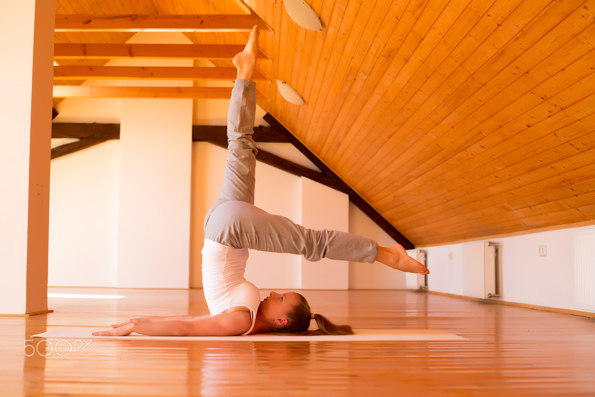 Woman practicing Yoga in a Studio
