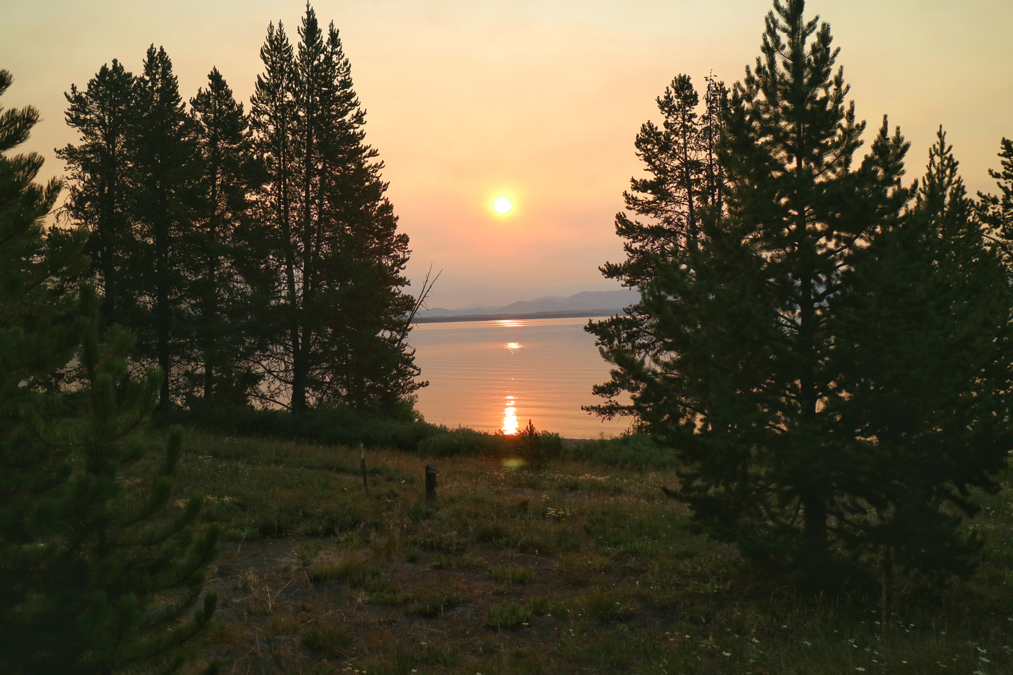 Canon EF-M 18-55mm F3.5-5.6 IS STM sample photo. Yellowstone lake @ sunup with the dubois fire turning the sky red. photography