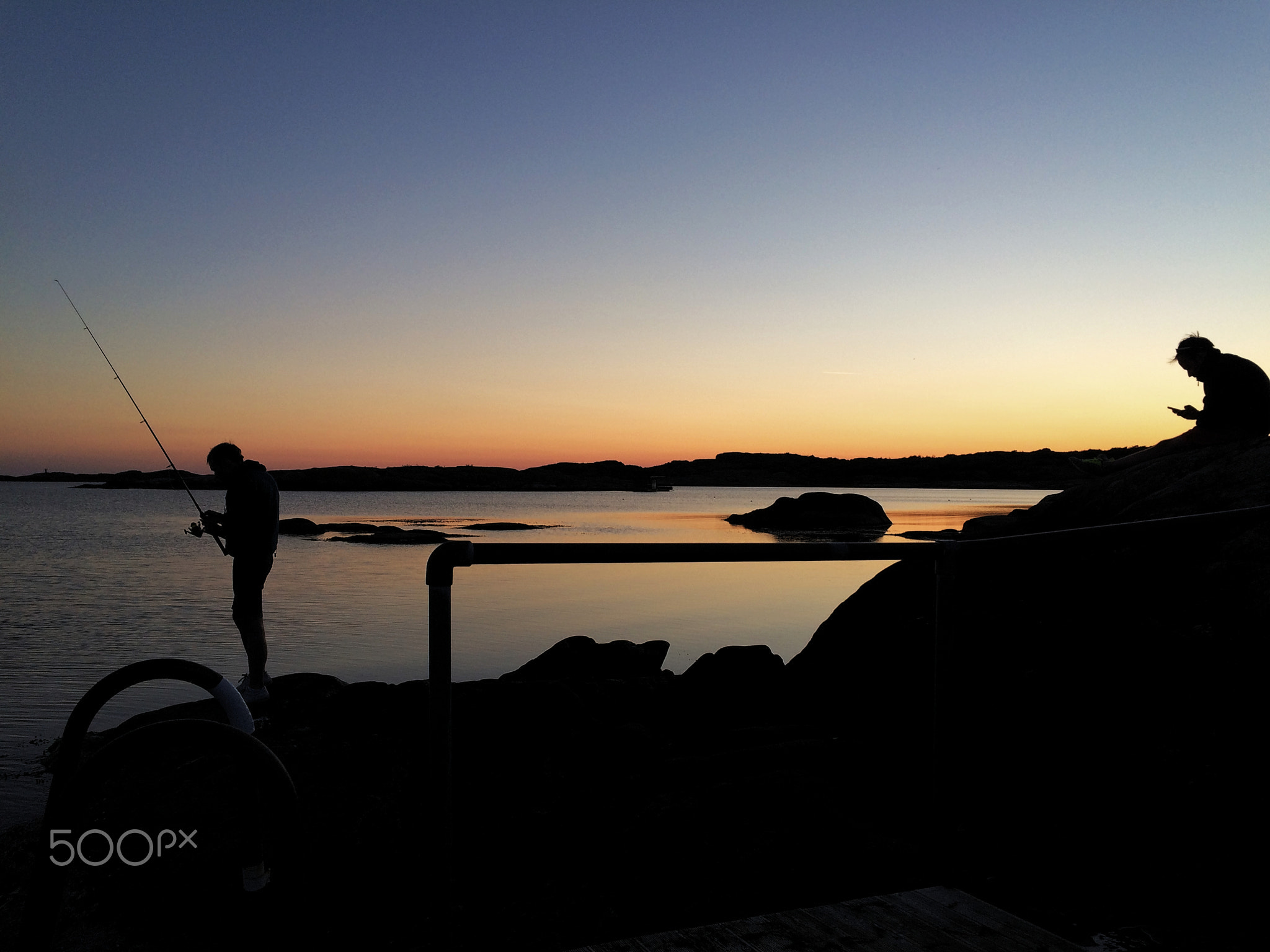 Two guys fishing on seacoast