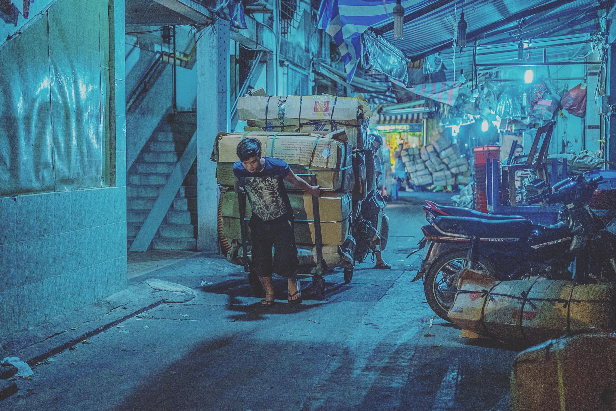 Sony a7S II + Sony FE 50mm F1.8 sample photo. Pulling boxes at the flower market. ho chi minh city. vietnam. photography