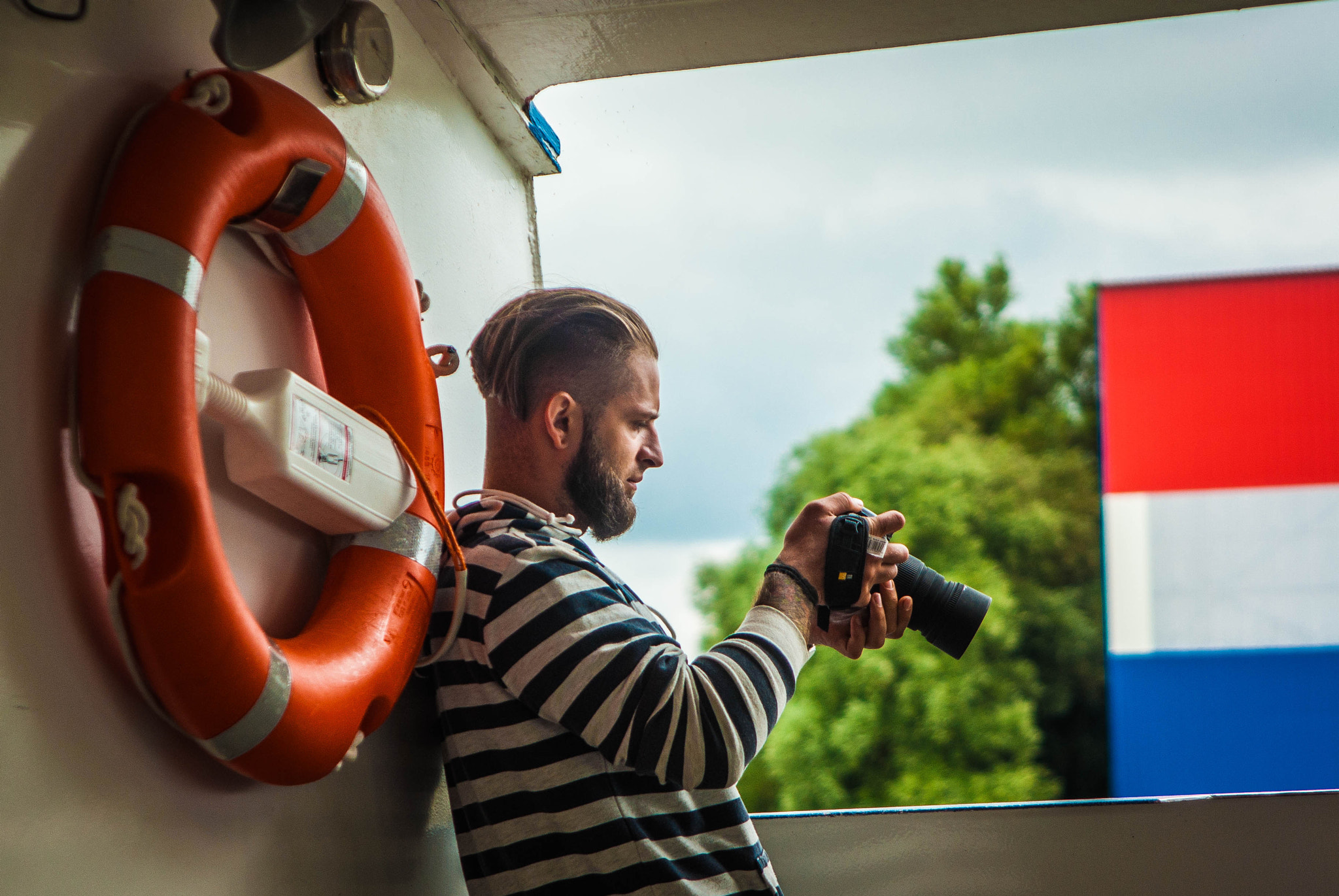 Pentax K200D sample photo. Photographer on a waterbus in netherlands photography