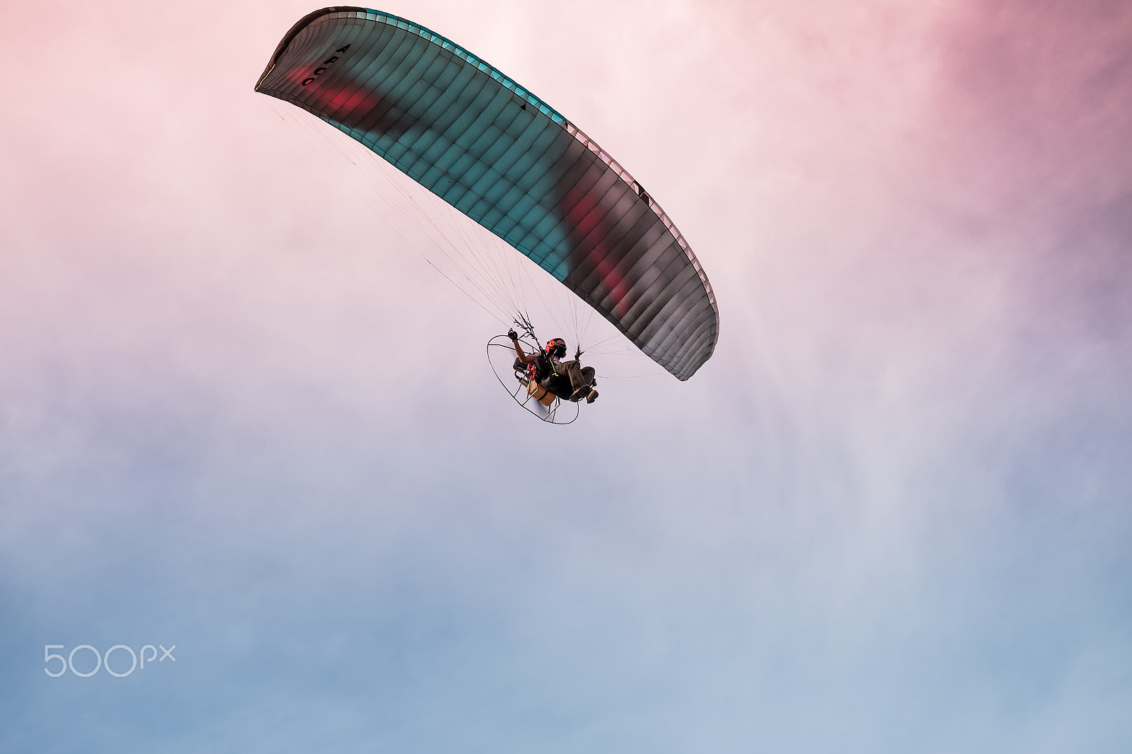 Fujifilm X-A2 + Fujifilm XC 50-230mm F4.5-6.7 OIS II sample photo. Paraglider flies on background of sunset sky photography