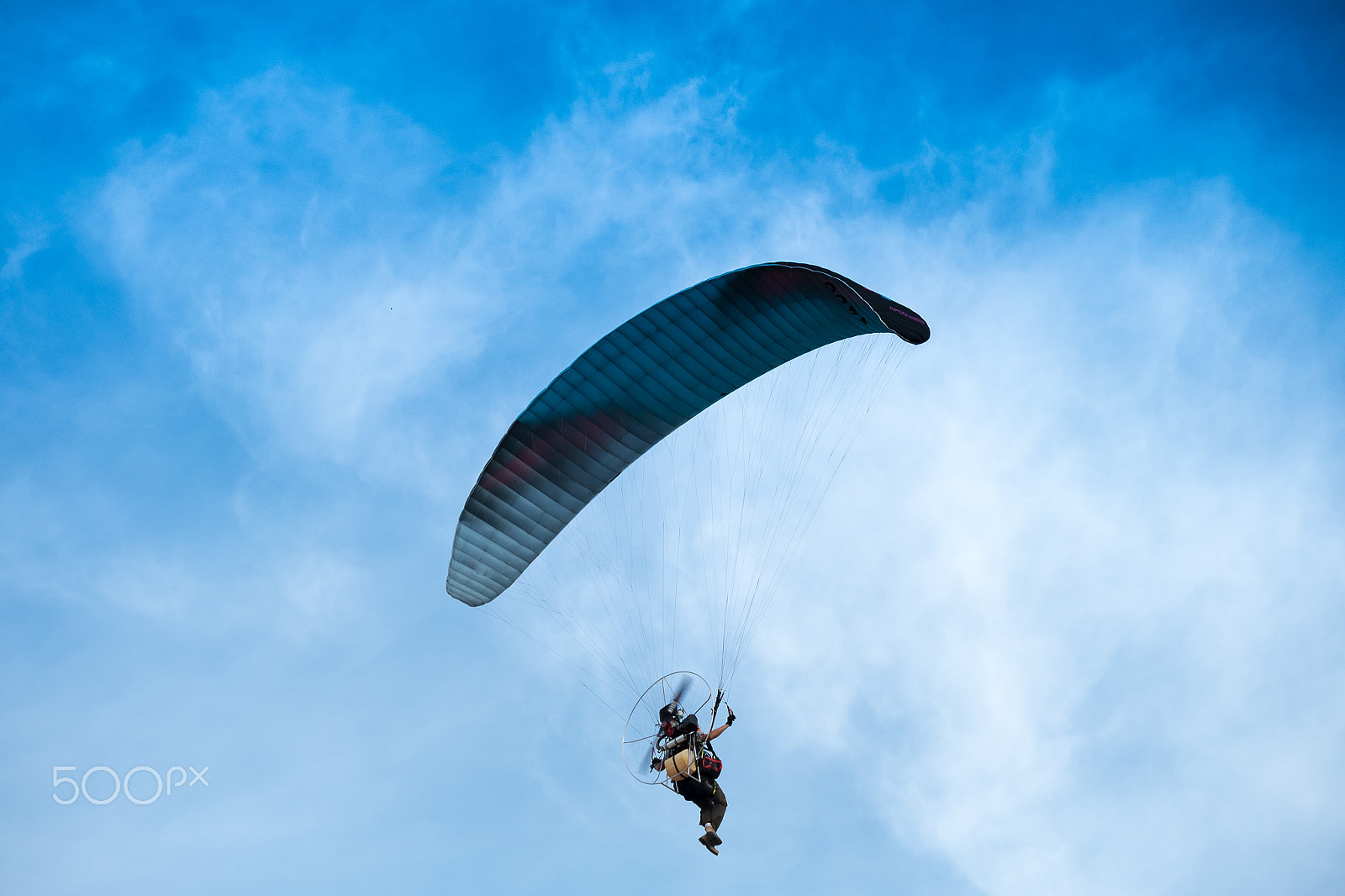 Fujifilm X-A2 + Fujifilm XC 50-230mm F4.5-6.7 OIS II sample photo. Paraglider flies on background of sunset sky photography