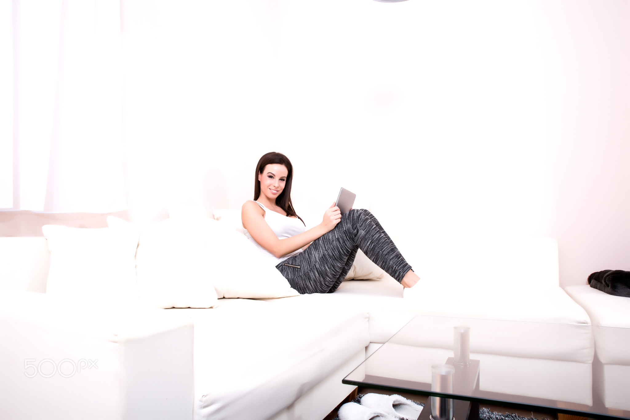 Young woman using a Tablet PC on the Sofa