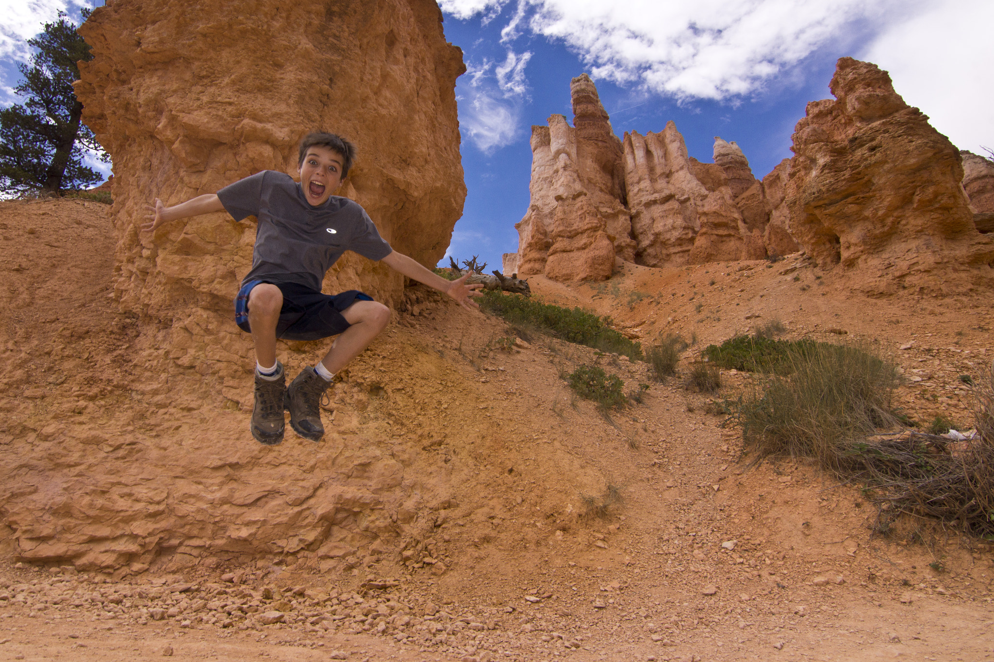 Sony SLT-A65 (SLT-A65V) + 20mm F2.8 sample photo. Son jumping of joy in bryce national park. photography