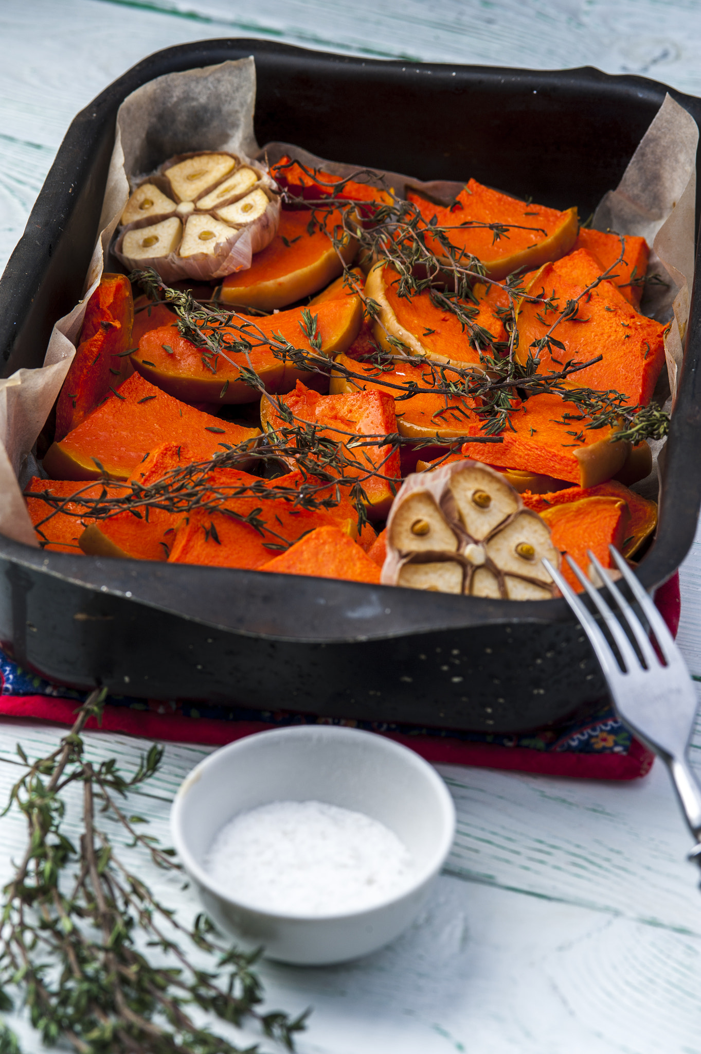 Nikon D700 + AF Micro-Nikkor 105mm f/2.8 sample photo. Baked pumpkin with thyme, olive oil and garlic on baking tray with fork and cup of salt. vertical... photography