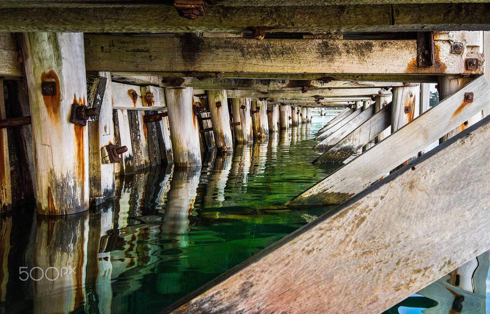 Canon EOS 7D + Canon EF 16-35mm F4L IS USM sample photo. Under jetty green water photography