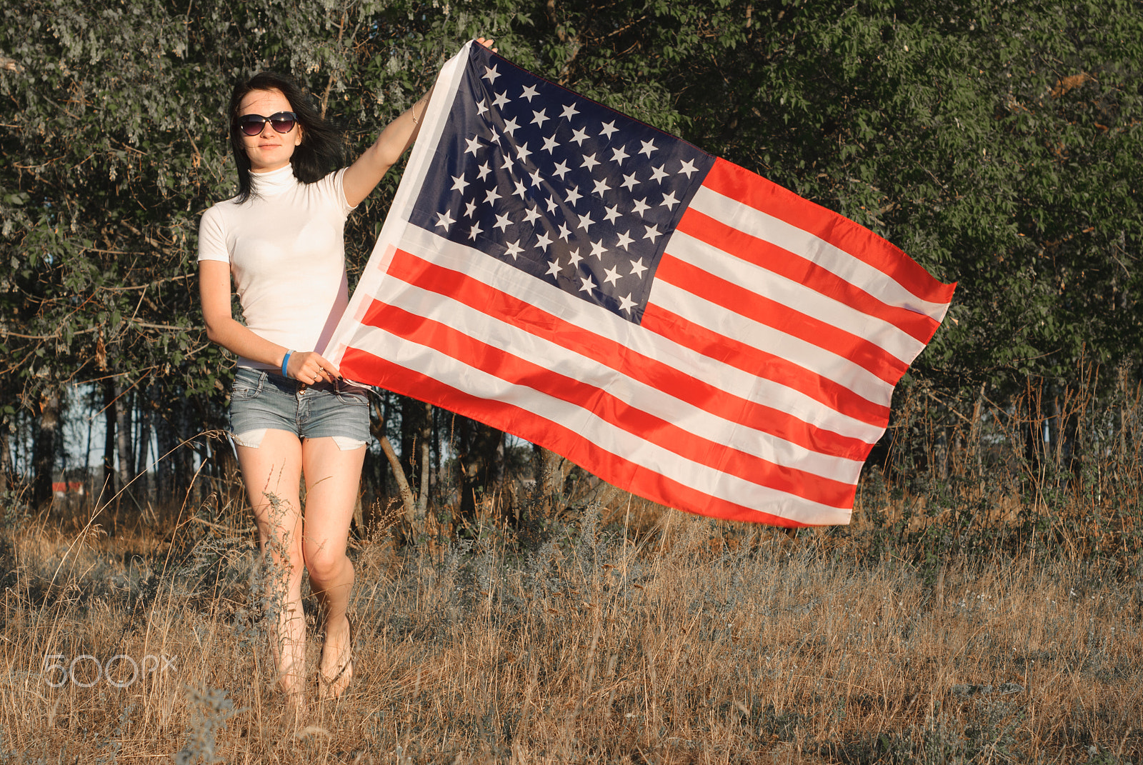 Nikon D80 sample photo. The girl with the american flag outdoors, stars and stripes flag flutters in the wind, photography