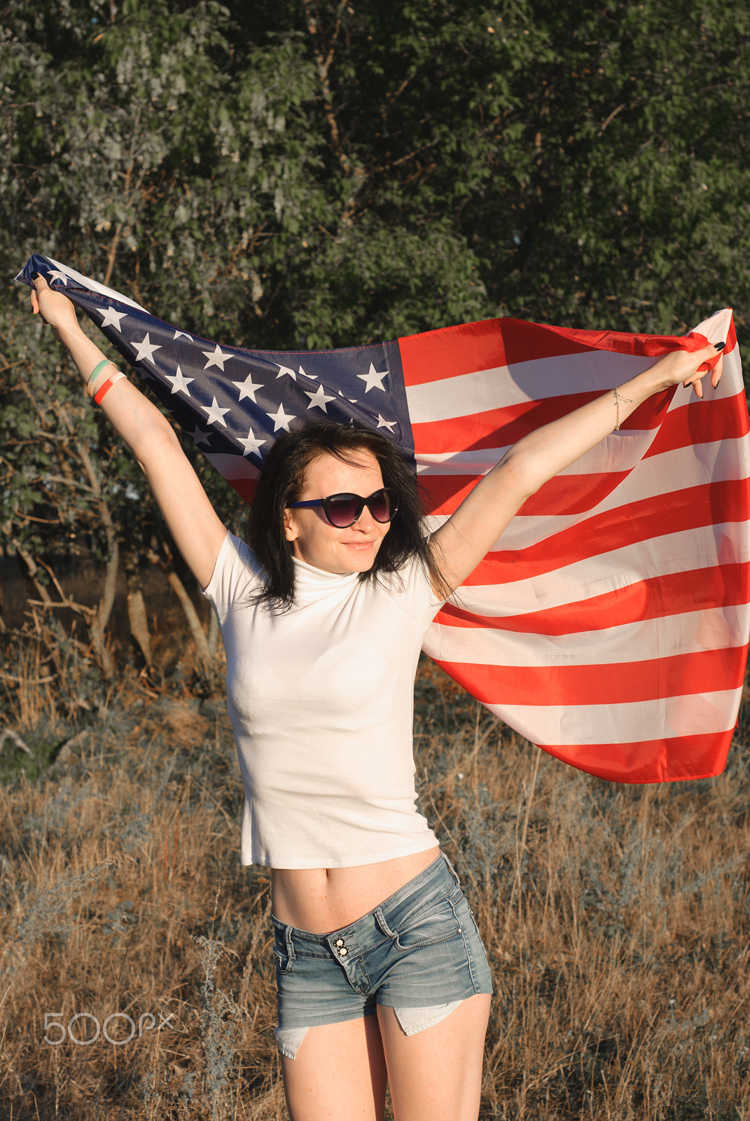 Nikon D80 + AF Nikkor 50mm f/1.8 N sample photo. The girl with the american flag outdoors, stars and stripes flag flutters in the wind, photography