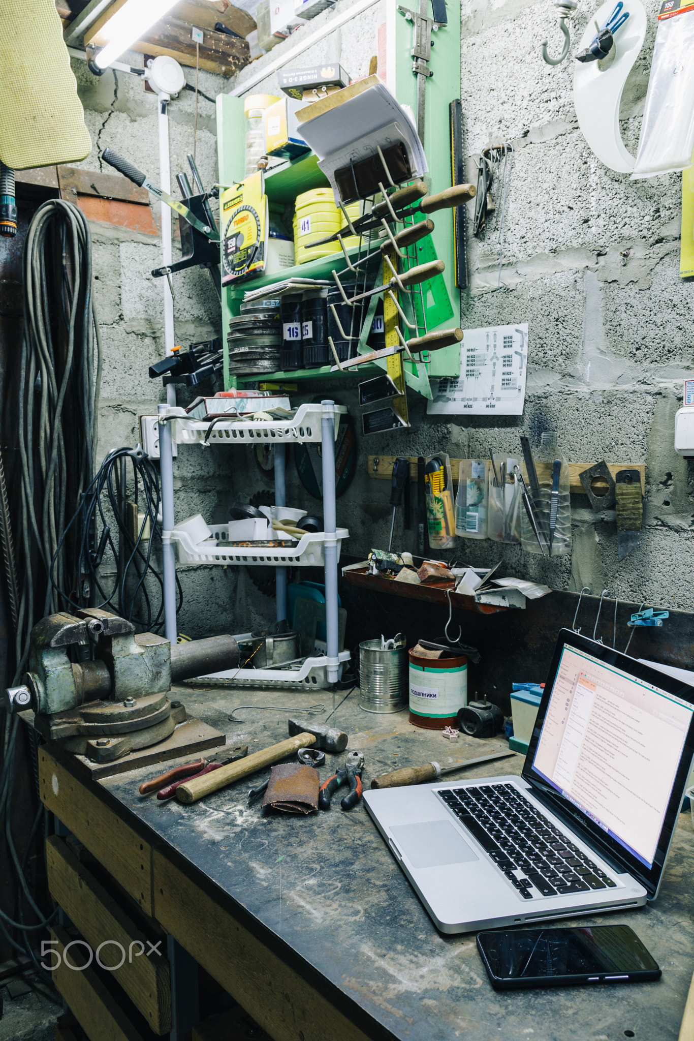 View of old tools,laptop and phone on table