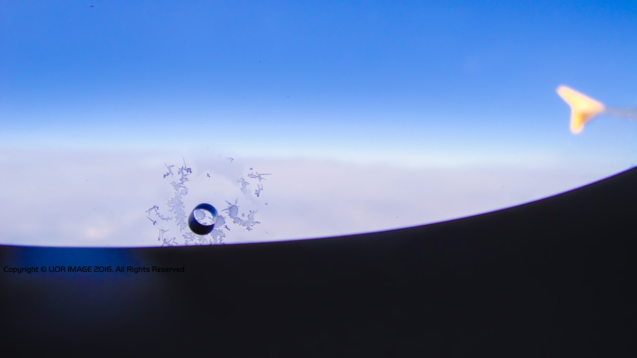 Sony DSC-T900 sample photo. Tiny face on the plane window photography
