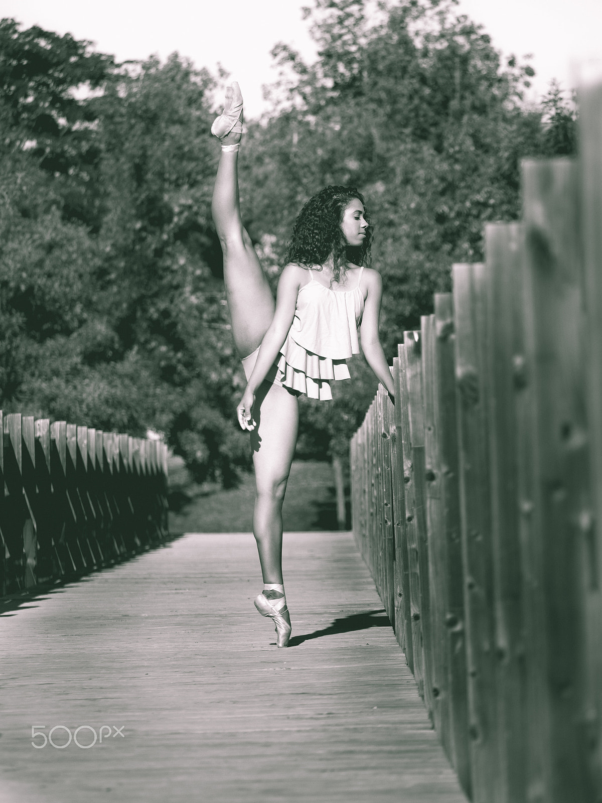 Panasonic Lumix DMC-GH3 sample photo. Latin dancer with leg raised above his head, monochrome photography