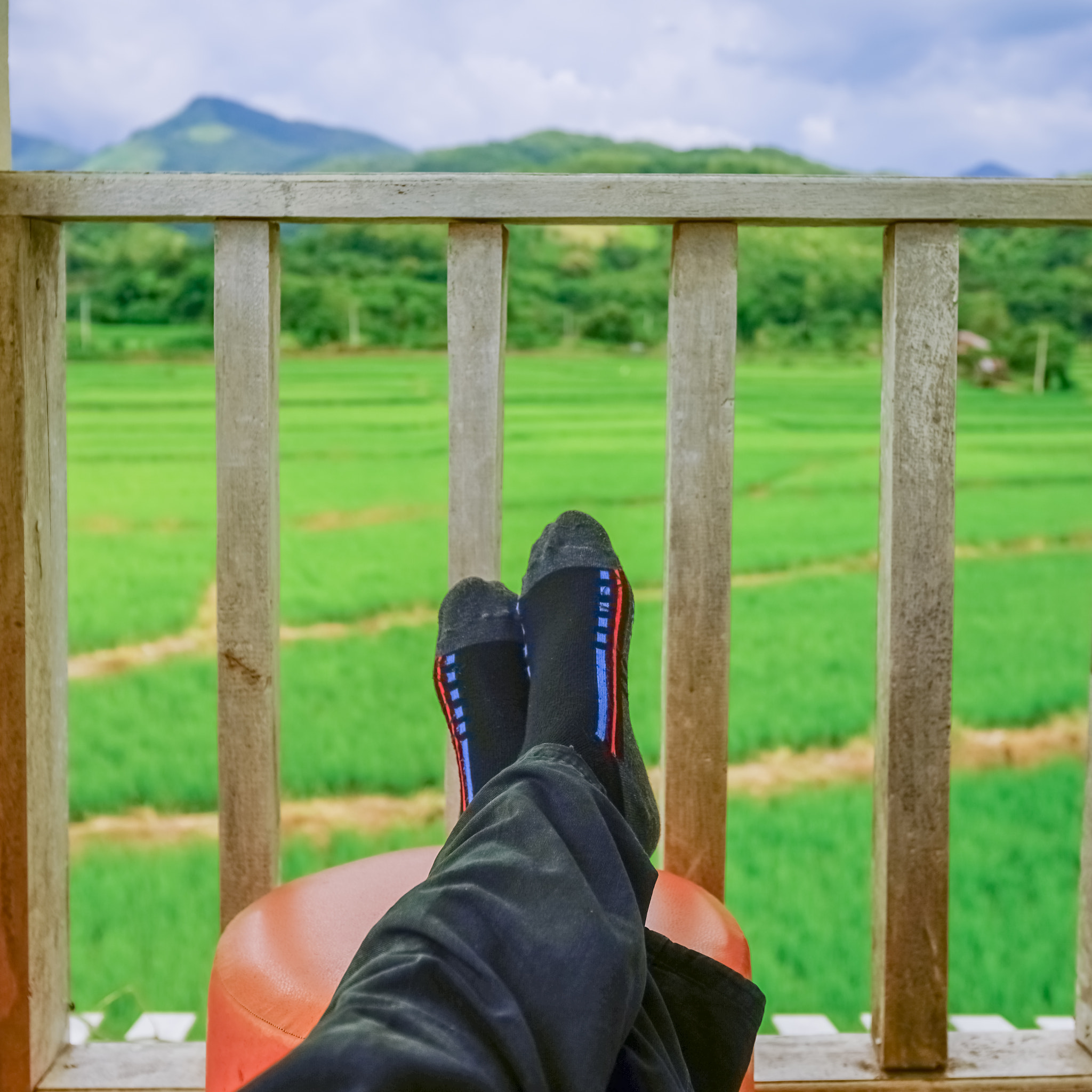 Sony a7 + Sony Vario-Sonnar T* 16-35mm F2.8 ZA SSM sample photo. Man relaxed on chair looking on rice fields in thailand photography