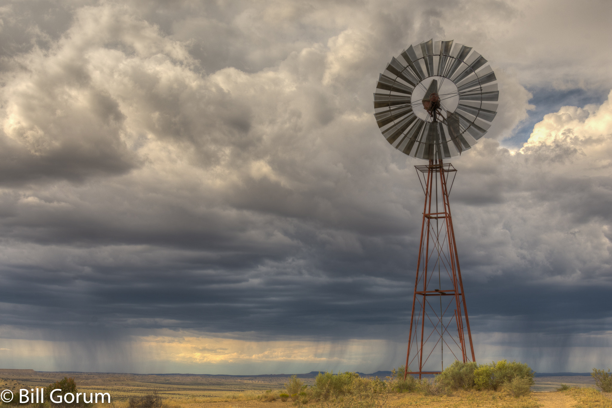 Nikon D7200 + Nikon AF-S Nikkor 24-85mm F3.5-4.5G ED VR sample photo. Widmill and distant thunderstorms, new mexico. photography