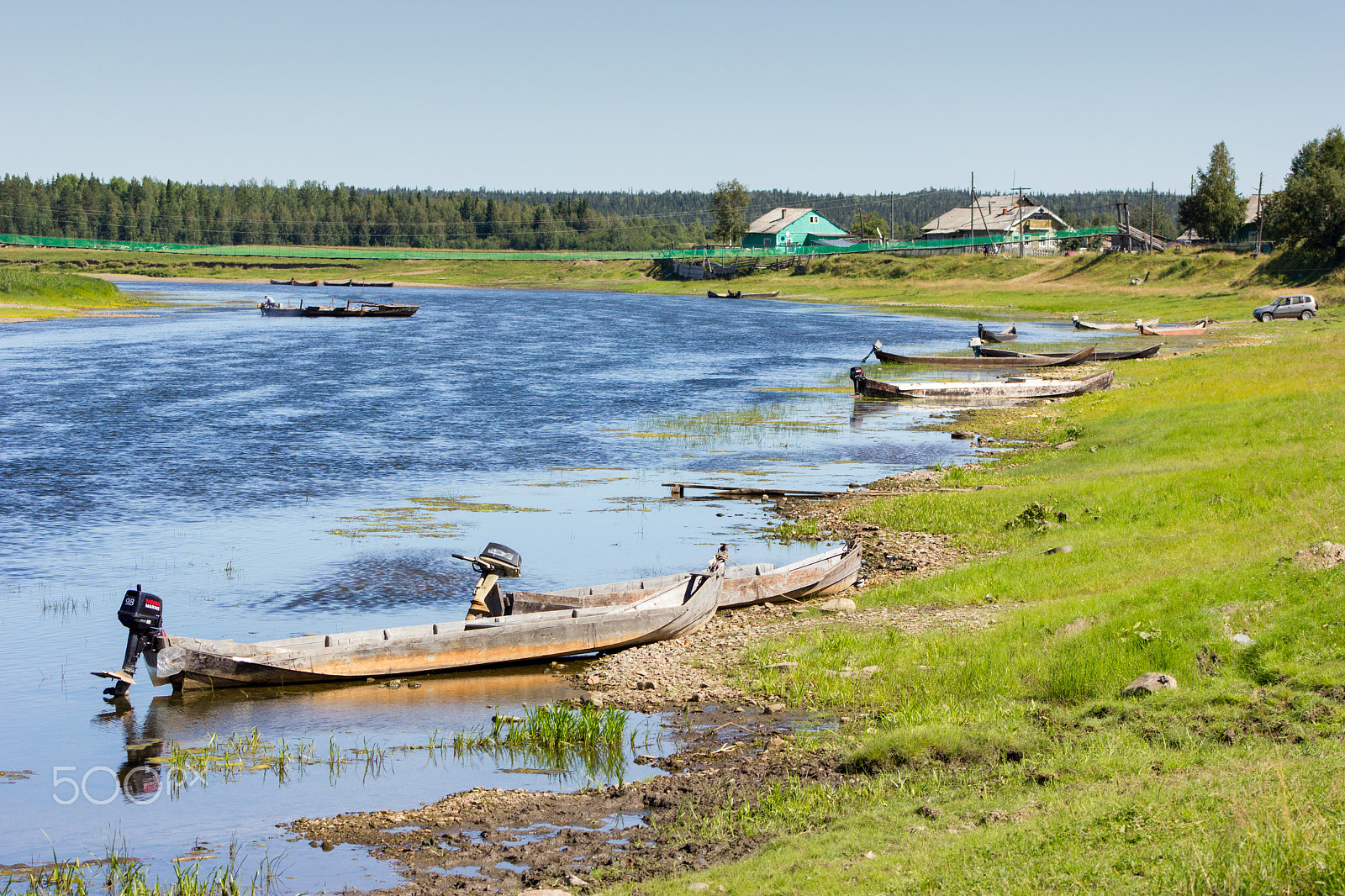 Canon EF 75-300mm f/4-5.6 USM sample photo. Rural landscape with river, handmade boats and houses photography