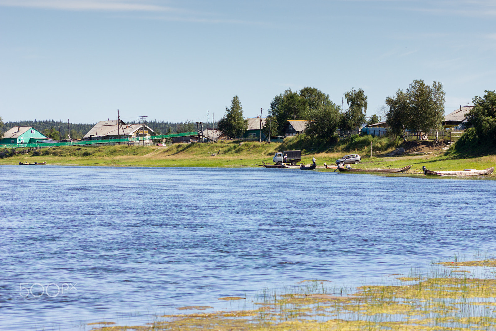 Canon EF 75-300mm f/4-5.6 USM sample photo. Rural landscape with river, handmade boats and houses photography