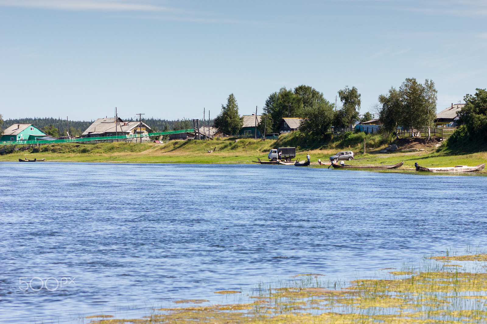 Canon EOS 550D (EOS Rebel T2i / EOS Kiss X4) + Canon EF 75-300mm f/4-5.6 USM sample photo. Rural landscape with river, handmade boats and houses photography