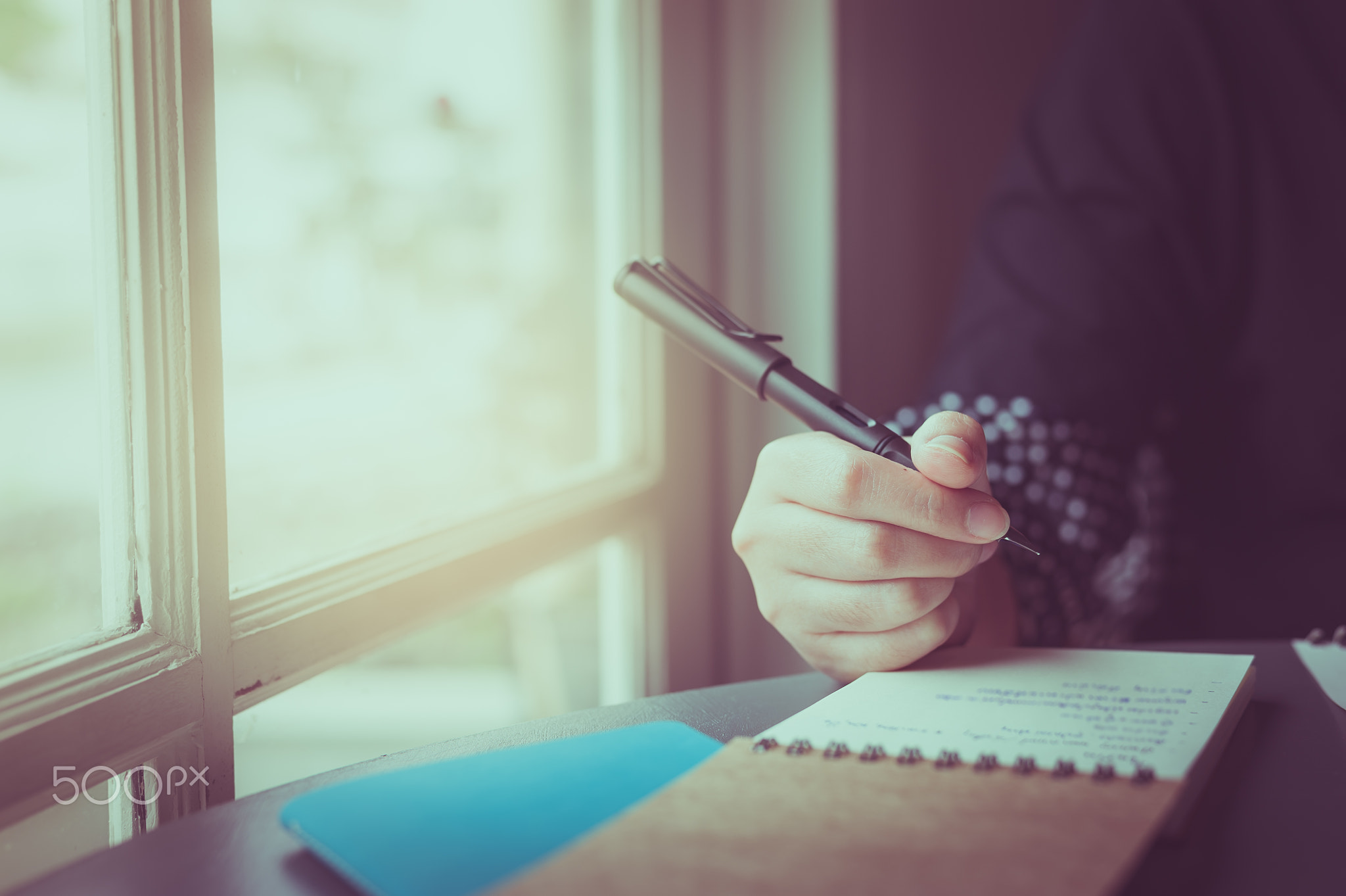 Woman hand writing on notepad