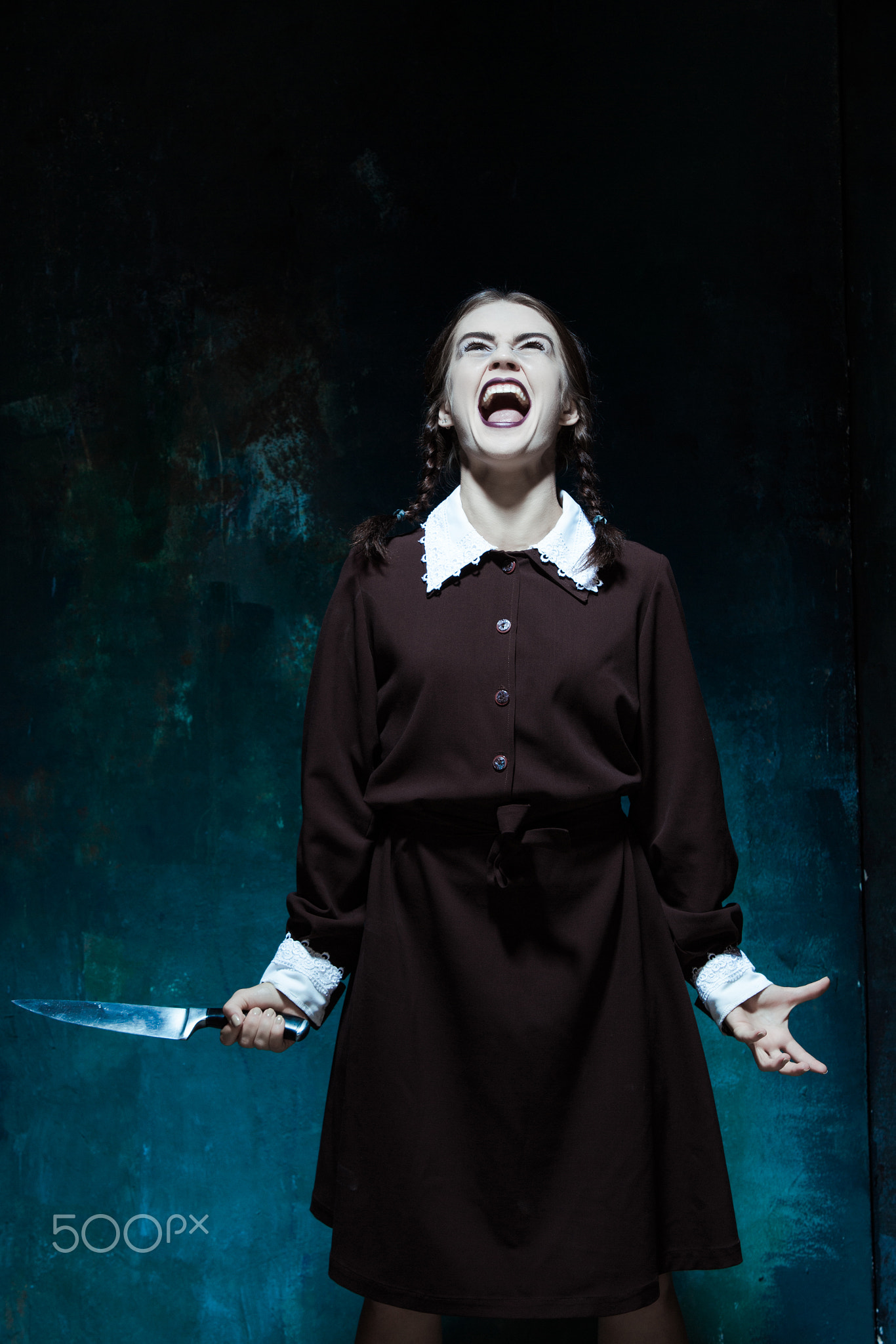 Portrait of a young girl in school uniform as killer woman