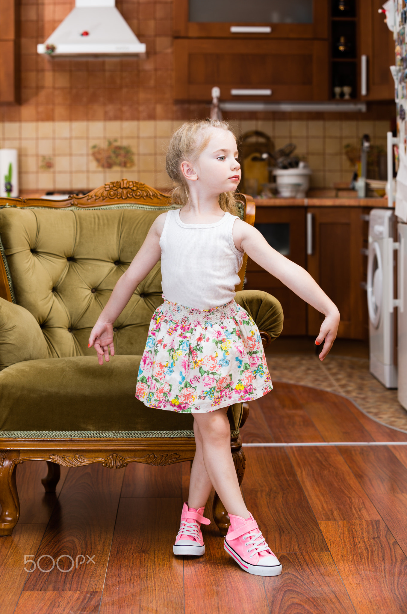 Beautiful little girl dancing in middle of lroom