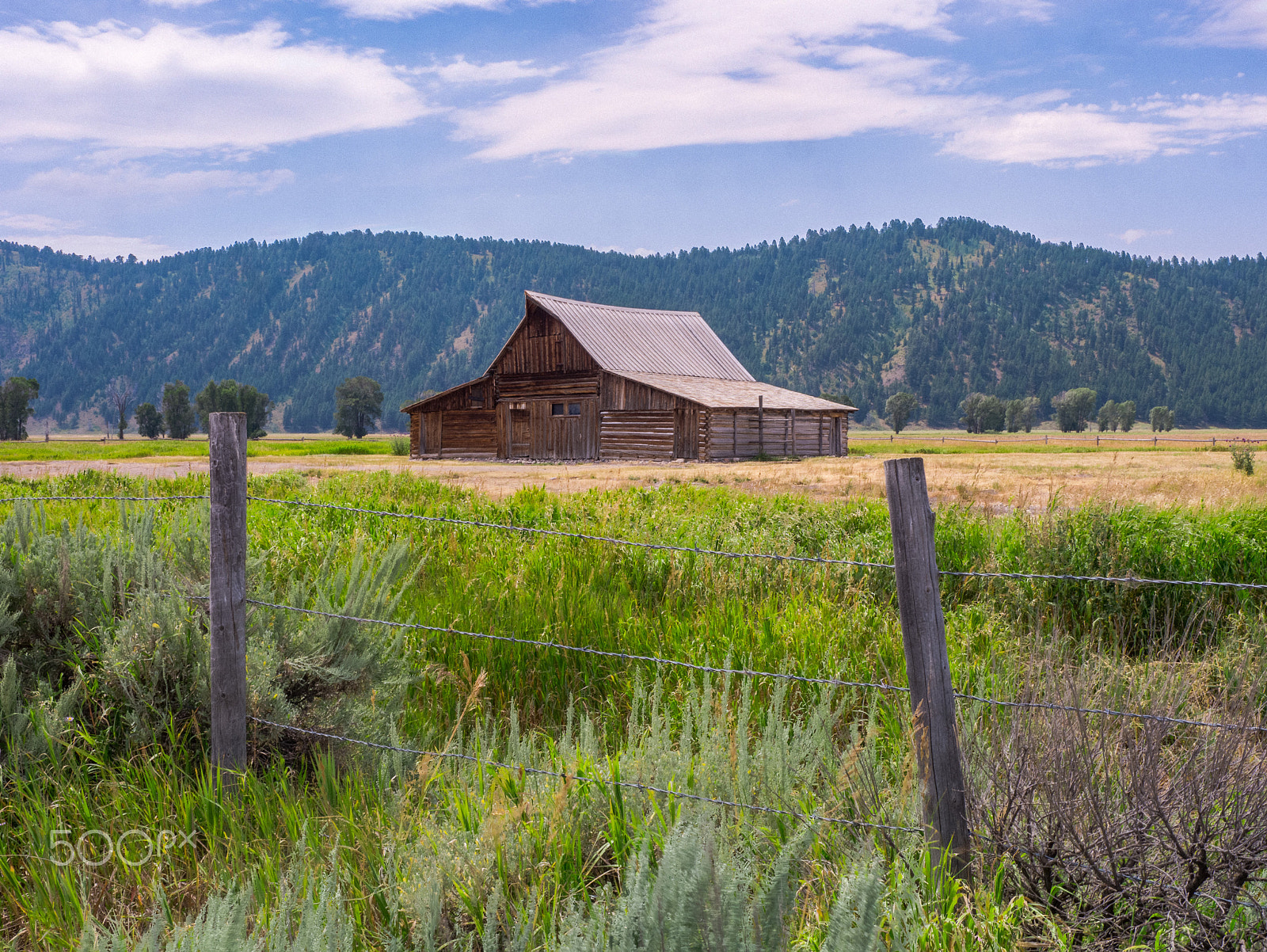Panasonic Lumix DMC-GX1 sample photo. Mormon row barn, fence and high clouds, near grand teton national park photography