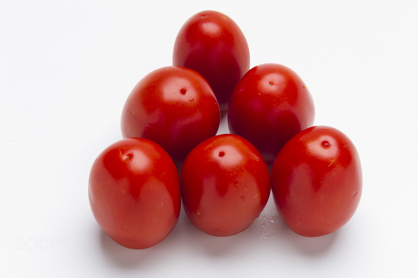 Canon EOS-1D Mark IV sample photo. Red plum tomatoes on a white background photography