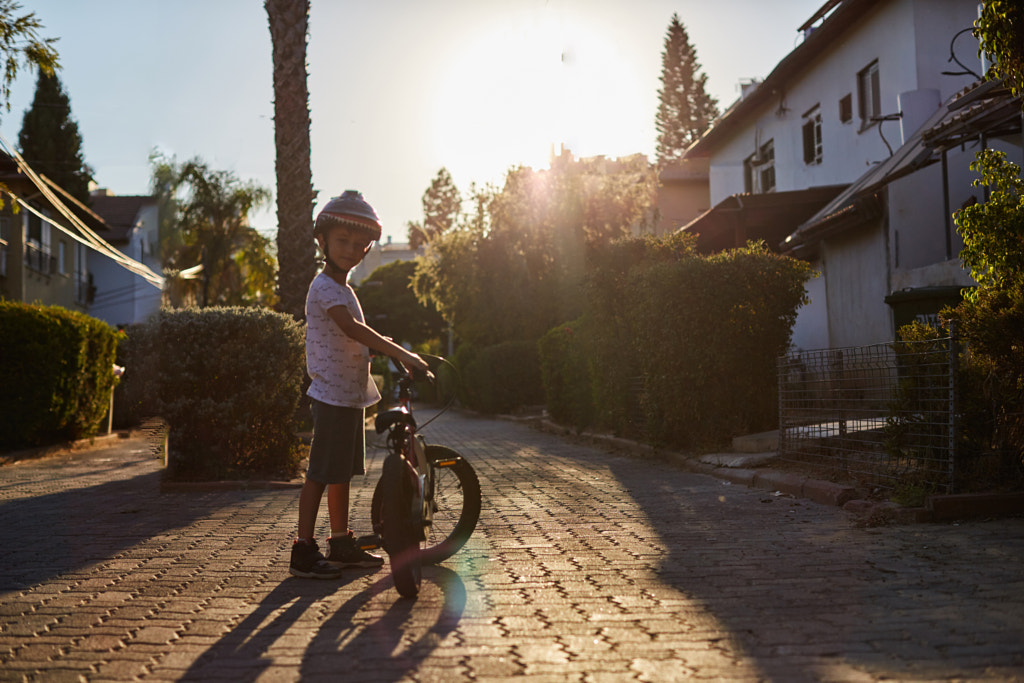 Portrait of cute boy with bicycle looking at camera by jenya pavlovski on 500px.com