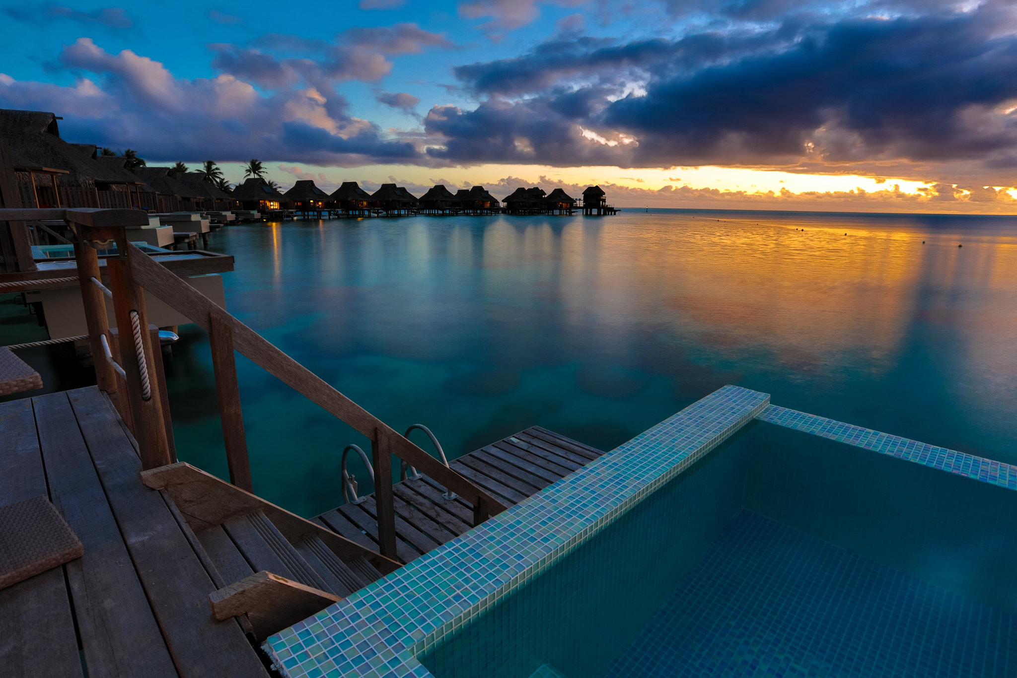 Canon EOS 5DS R + Canon EF 17-40mm F4L USM sample photo. Sunset in paradise - tranquil view of overwater bungalows, hilton nui bora bora photography