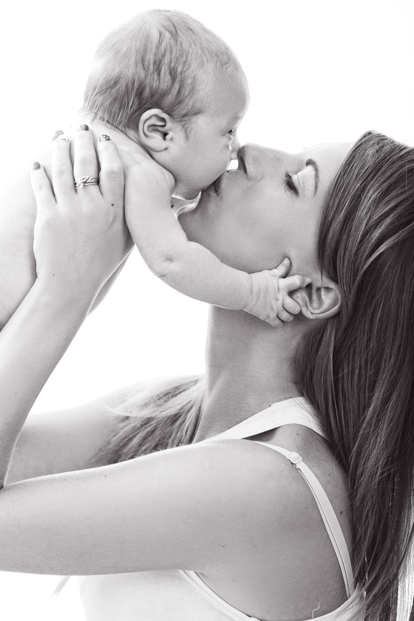 Mother kisses her infant baby